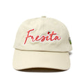Front view of Khaki Fresita Dad Hat with embroidered red script and small strawberry detail on the letter i