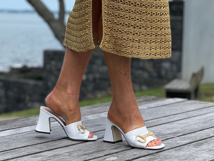 Classy European women's sandals with gold bit detail. Mule style on chunky block heel. Wedding or special occasion slide. In white.