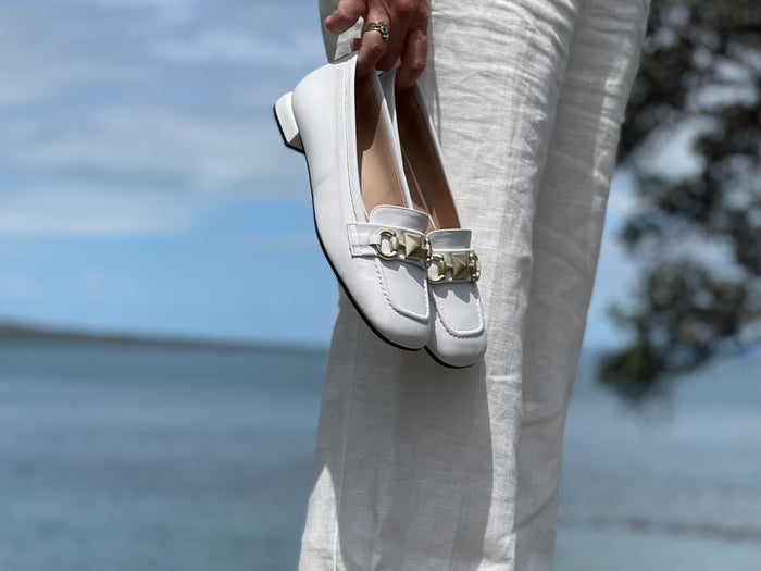 A pair of white loafers with gold embellishment detailing, comfortable, quality European women's shoes. Soft square toe available in white.